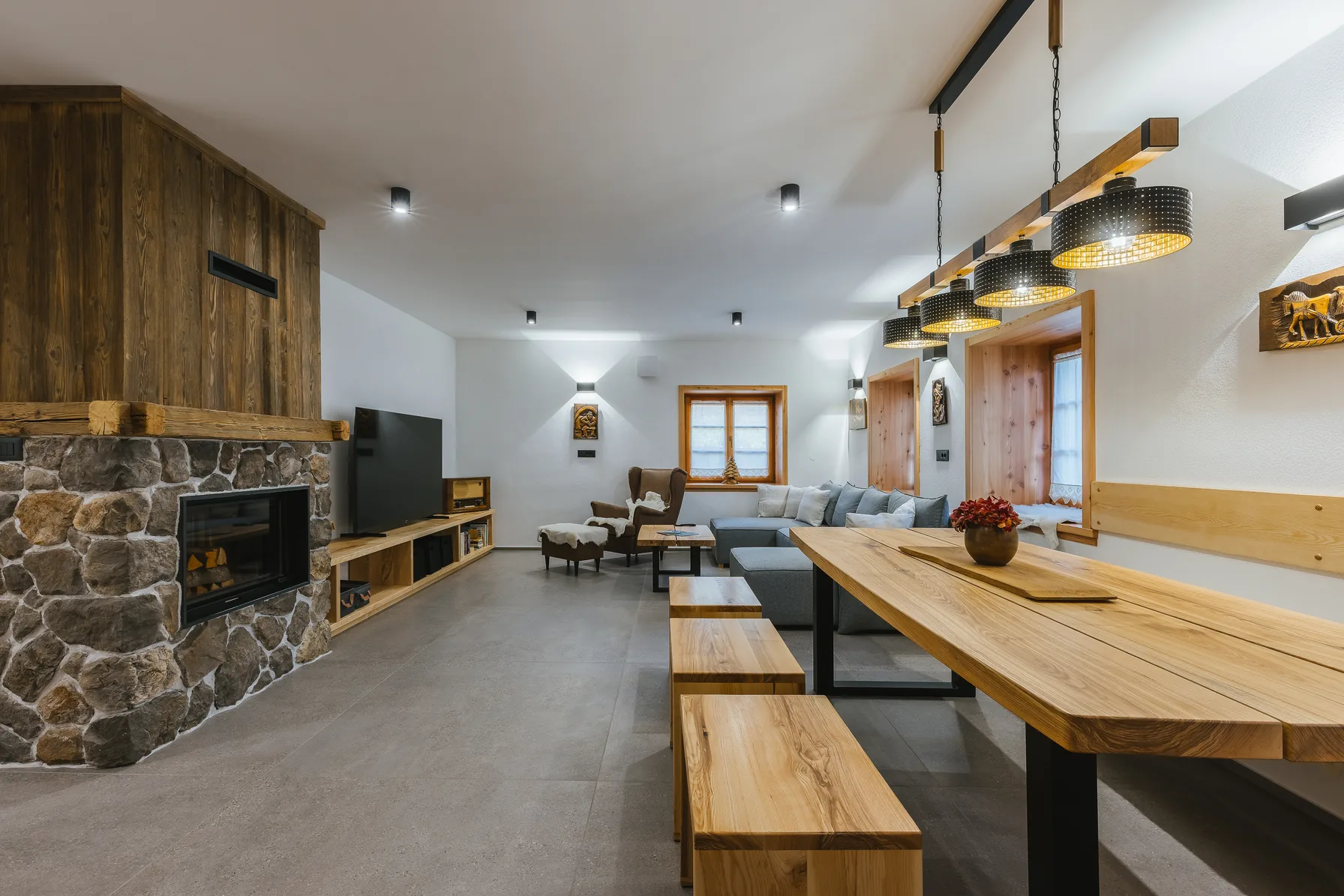 Open-plan living room with stone fireplace, Alpine House 77, Podkoren