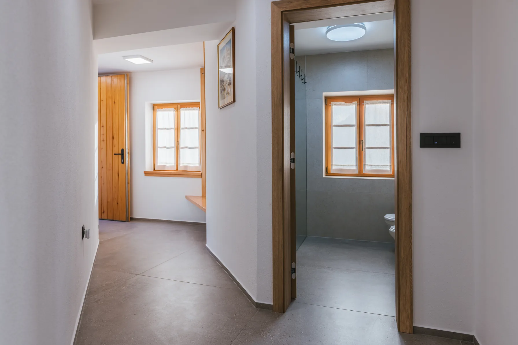 Hallway with doorway to bathroom and living area