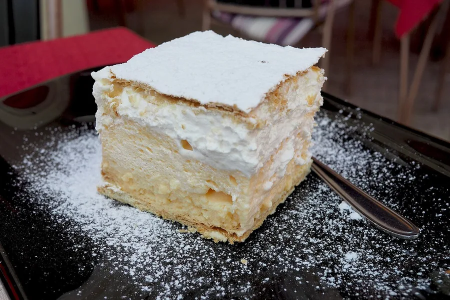 A square slice of Bled kremšnita cream cake