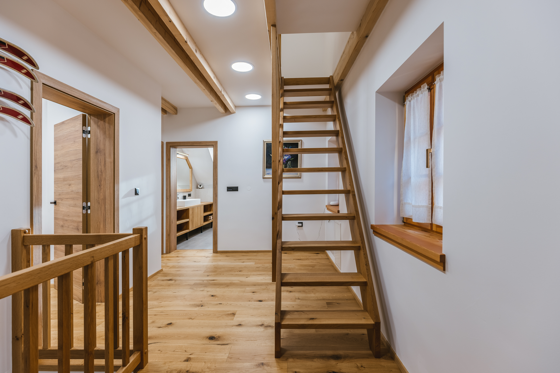 Upstairs landing with ladder to attic and bathroom