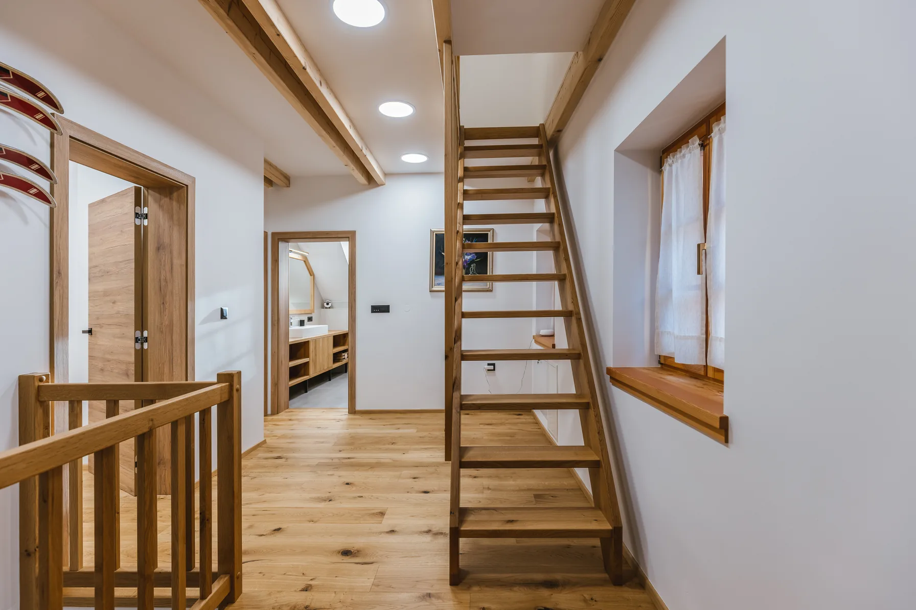 Upstairs landing with ladder to attic and bathroom