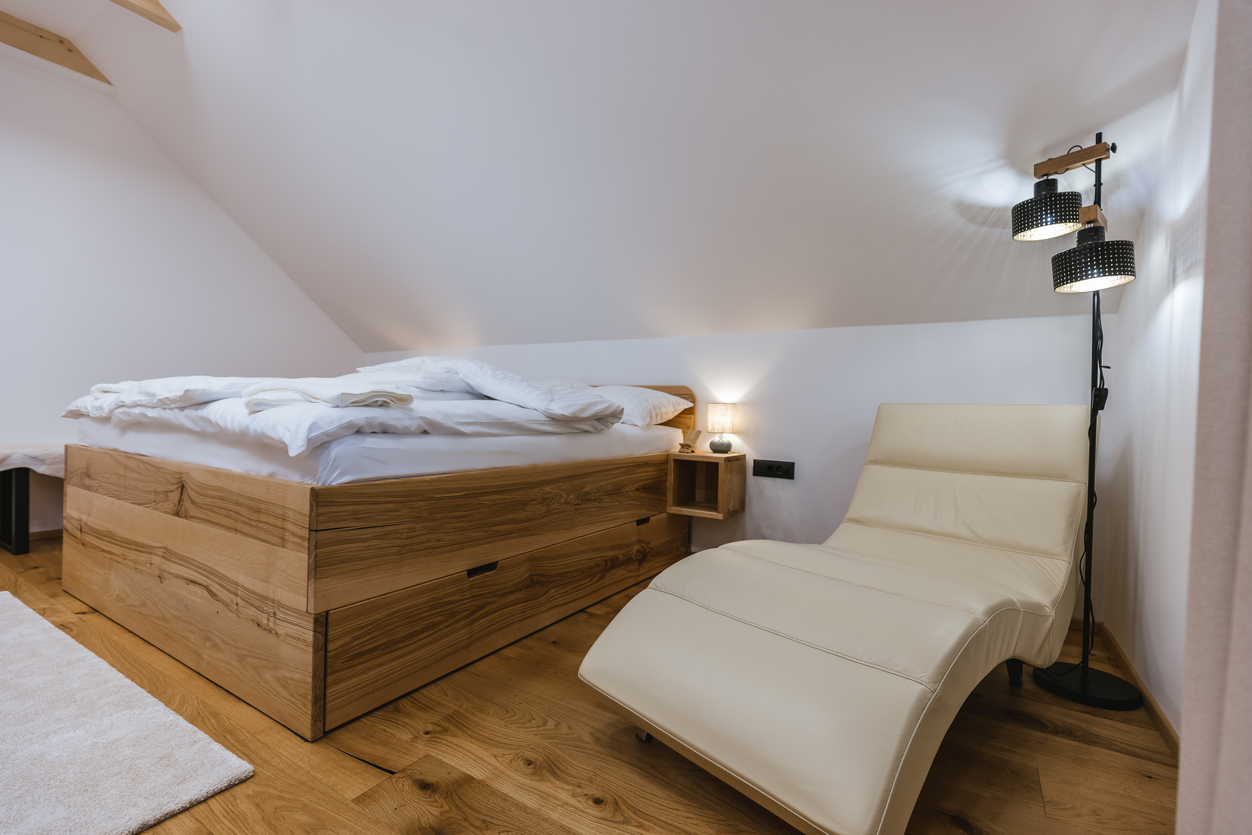 King bedroom with chaise lounge and floor lamp