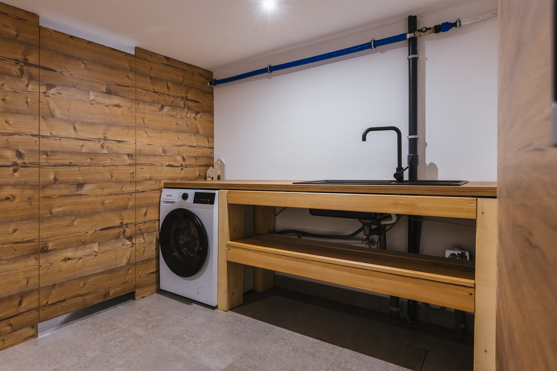 Laundry room with washing machine and utility sink
